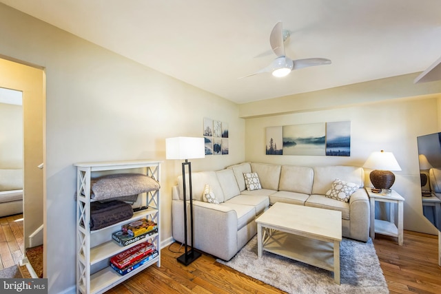 living area featuring wood finished floors and a ceiling fan