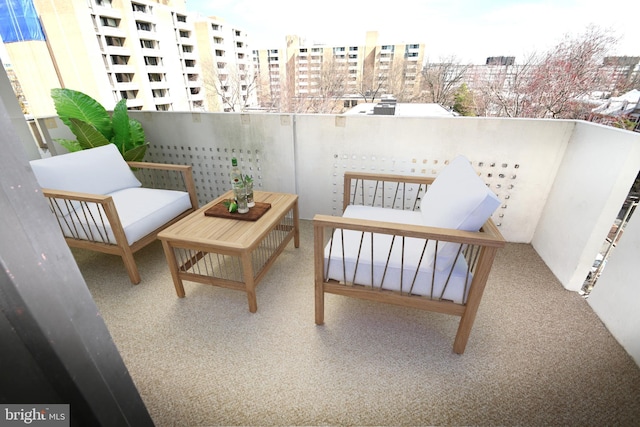 balcony featuring a view of city and outdoor lounge area