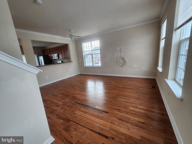 unfurnished living room featuring a ceiling fan, wood finished floors, baseboards, and ornamental molding