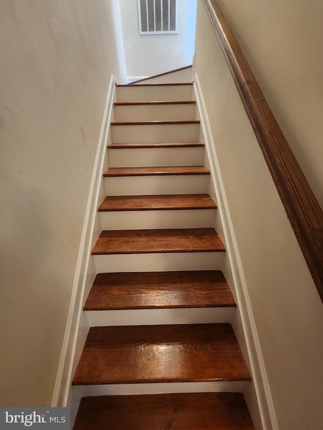 stairway featuring visible vents