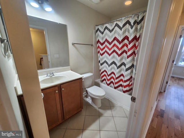 full bath with vanity, shower / bath combination with curtain, toilet, and tile patterned floors