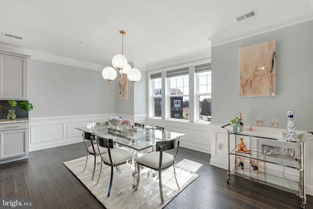 dining room with visible vents, an inviting chandelier, dark wood finished floors, and crown molding