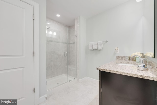 bathroom featuring recessed lighting, a stall shower, vanity, and baseboards