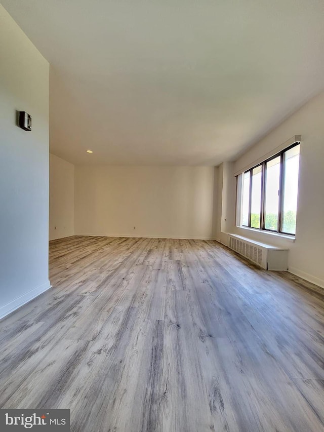 3100 S Manchester St Unit 909, Falls Church, VA 22044 - empty room featuring baseboards, radiator, and wood finished floors