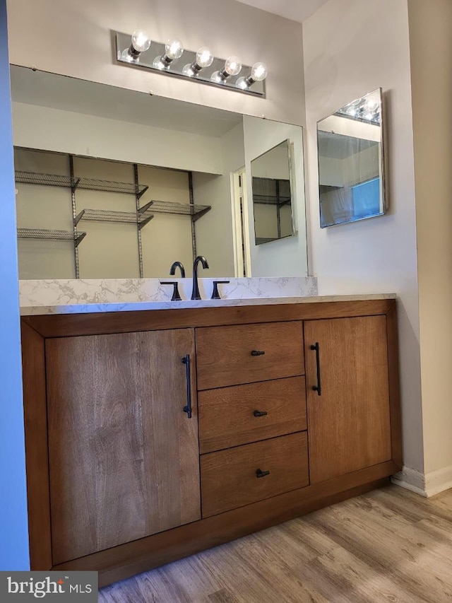 3100 S Manchester St Unit 909, Falls Church, VA 22044 - bathroom with vanity, wood finished floors, and baseboards