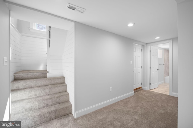 interior space featuring carpet flooring, recessed lighting, visible vents, and baseboards