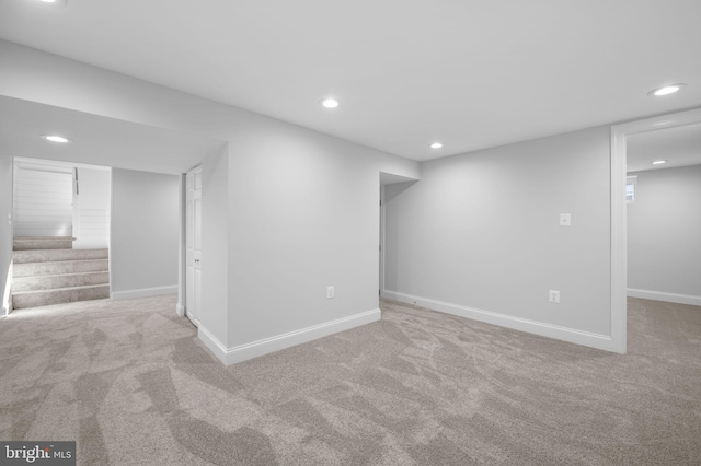 finished basement with recessed lighting, stairway, baseboards, and carpet flooring