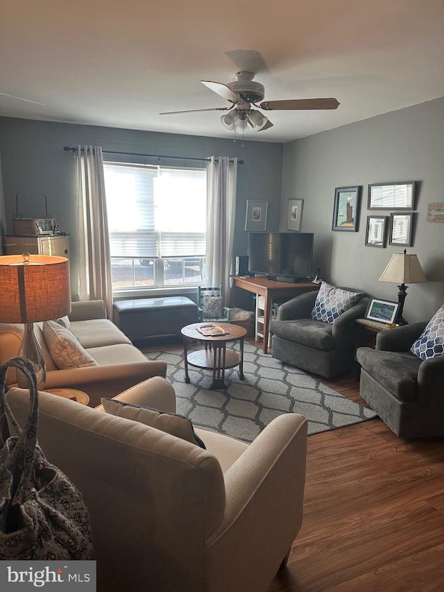 living area featuring ceiling fan and wood finished floors