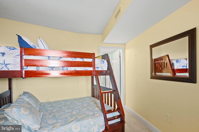 bedroom featuring visible vents, baseboards, and carpet floors