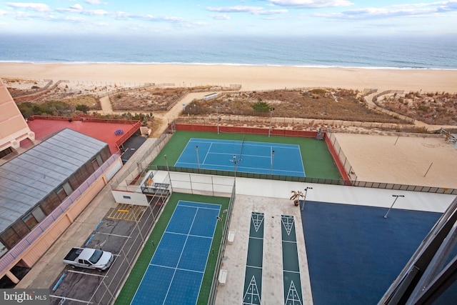 drone / aerial view with a beach view and a water view