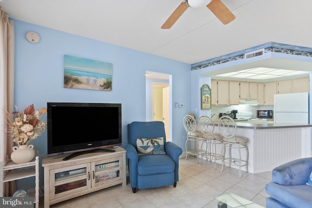 living area with light tile patterned floors and ceiling fan