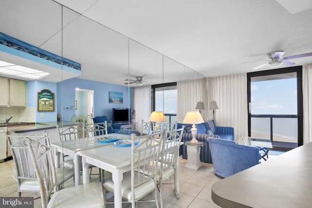 dining area featuring light tile patterned floors, plenty of natural light, and ceiling fan