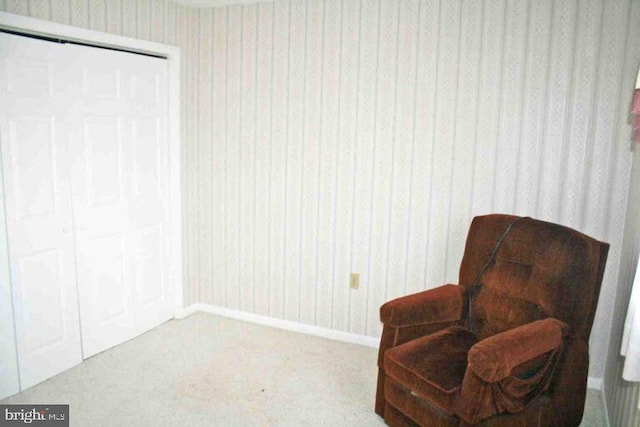 sitting room with carpet and baseboards