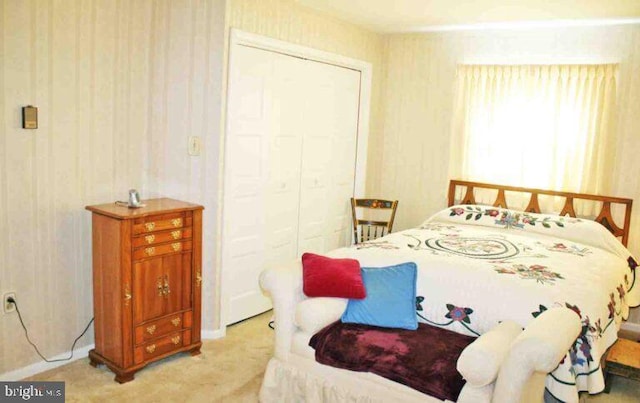 bedroom with light colored carpet and a closet