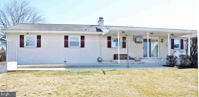 rear view of house with a yard, a patio, and a chimney