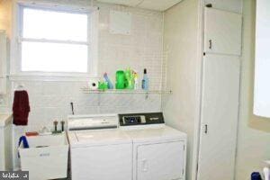 laundry area featuring a sink, washing machine and dryer, and laundry area