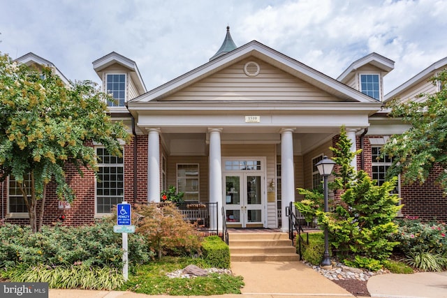 view of front of house featuring a porch and french doors