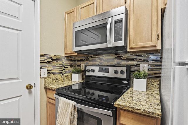 kitchen with light stone countertops, light brown cabinets, backsplash, and stainless steel appliances