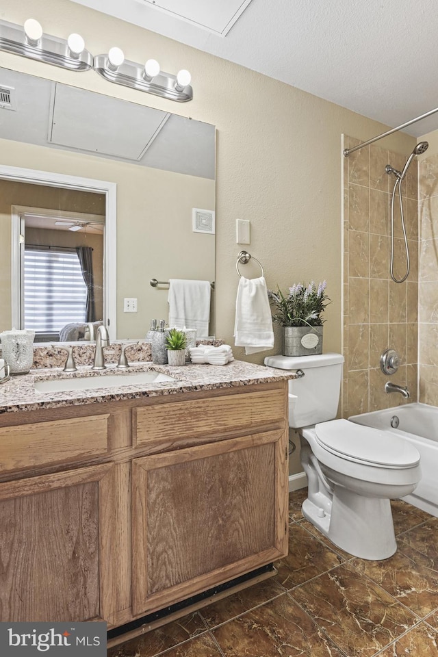 full bathroom with vanity, washtub / shower combination, visible vents, a textured ceiling, and toilet