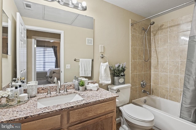 bathroom with visible vents, vanity, toilet, and shower / tub combo