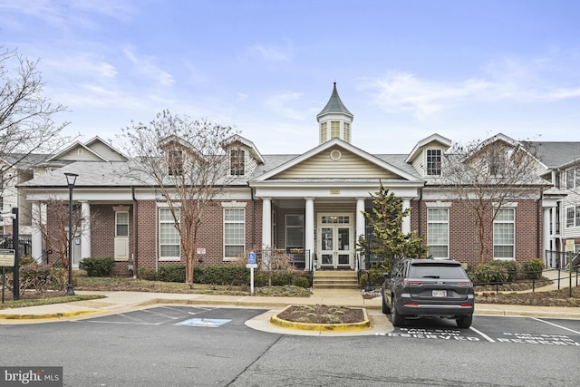 view of building exterior with uncovered parking