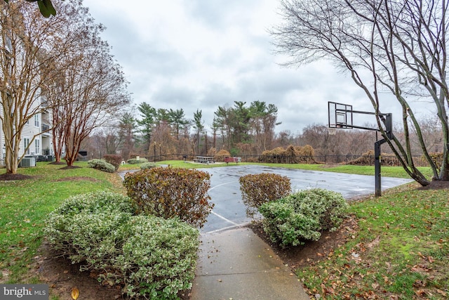 view of basketball court with a lawn and community basketball court