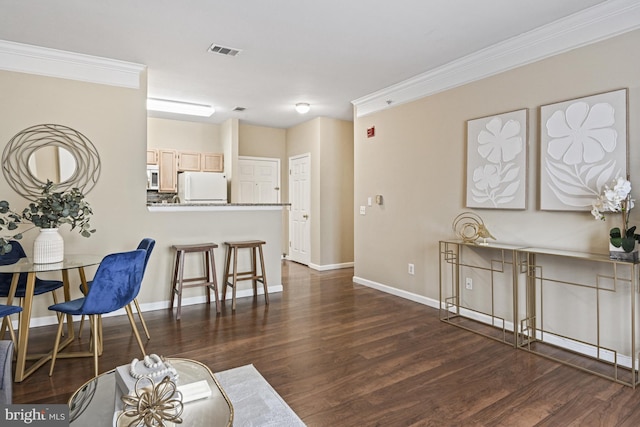 living area featuring visible vents, baseboards, dark wood-style flooring, and crown molding