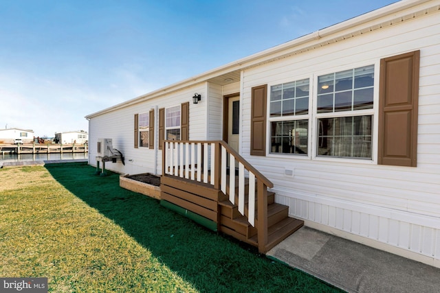 view of exterior entry with a lawn