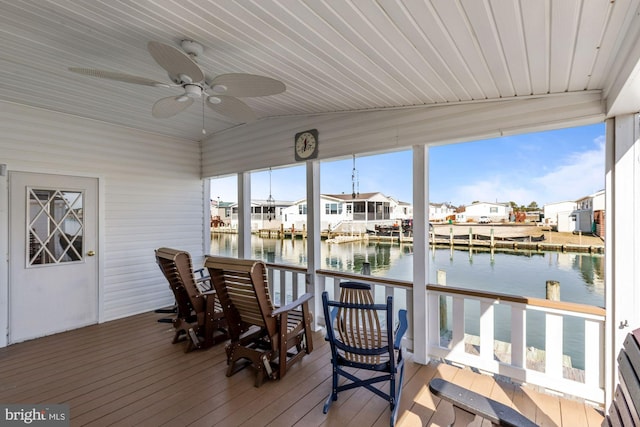 sunroom / solarium featuring ceiling fan, vaulted ceiling, wood ceiling, a water view, and a residential view