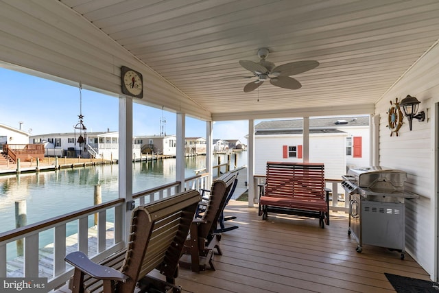 deck featuring a water view, a grill, and ceiling fan