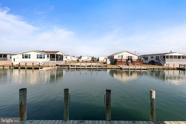 dock area featuring a residential view and a water view