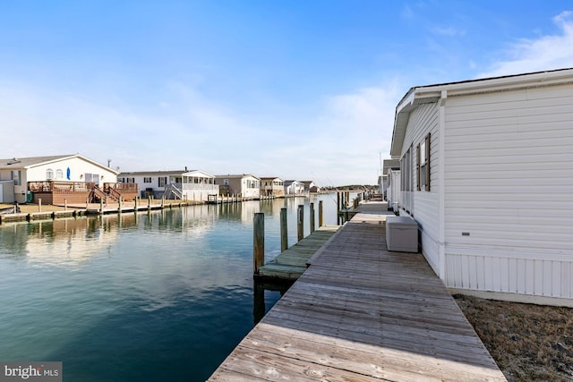 dock area with a residential view and a water view