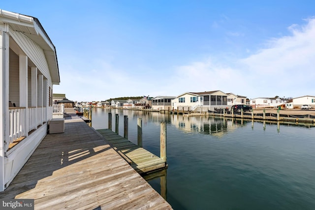 dock area featuring a residential view and a water view