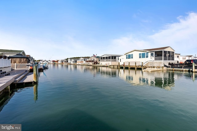 dock area with a residential view and a water view