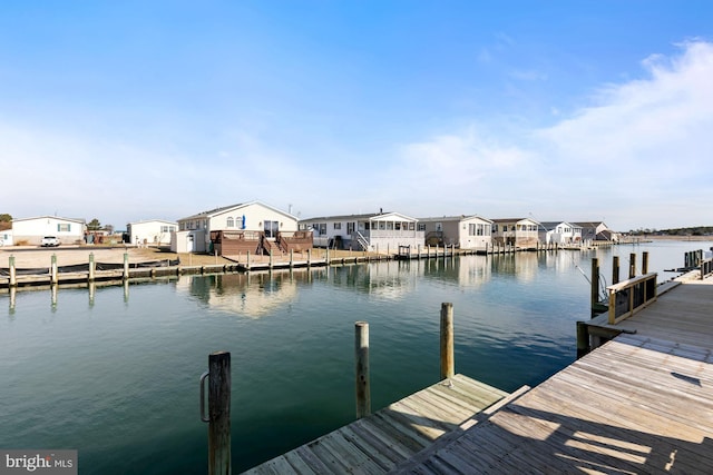 dock area featuring a residential view and a water view