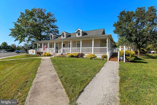 view of front of house with covered porch and a front yard