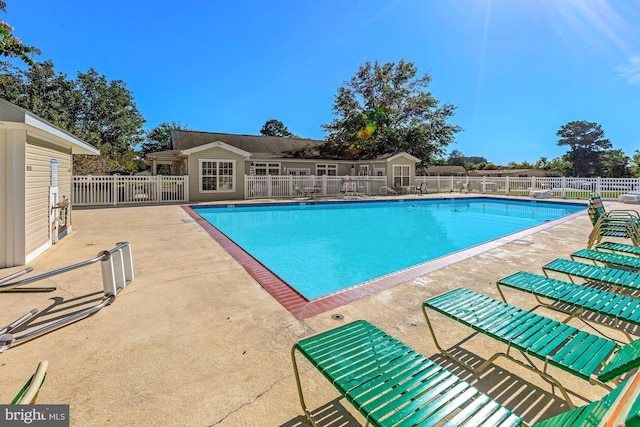 pool featuring a patio and fence