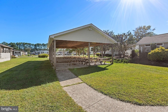 view of community featuring a gazebo, a yard, and a residential view