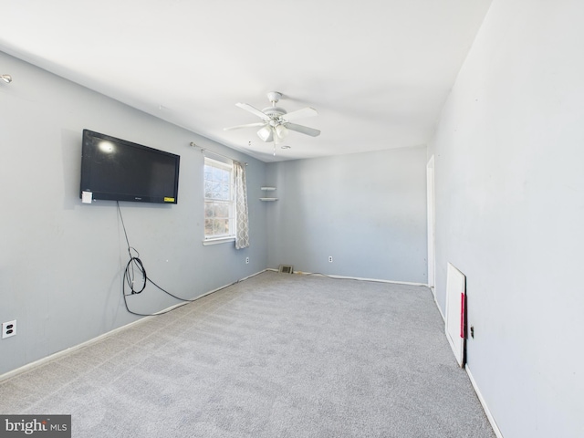 interior space with a ceiling fan, baseboards, and carpet floors