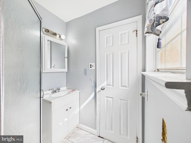 bathroom with vanity, baseboards, and marble finish floor