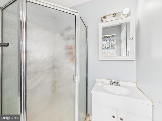 bathroom featuring vanity and a shower stall