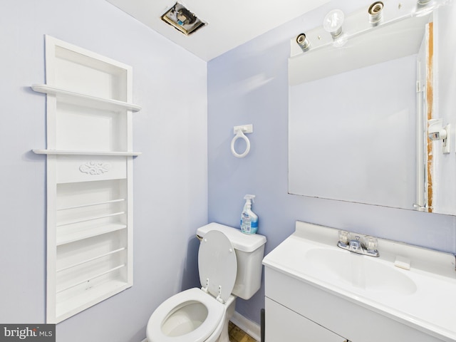 bathroom featuring toilet and vanity