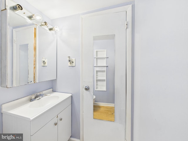 bathroom featuring toilet and vanity