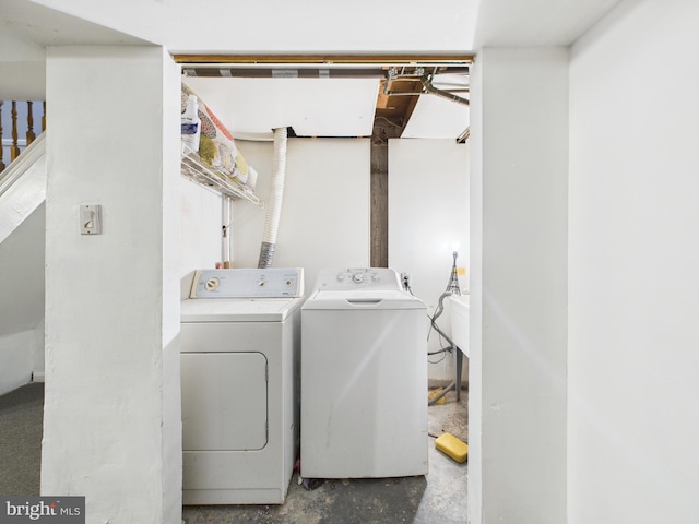 washroom featuring laundry area and washing machine and dryer