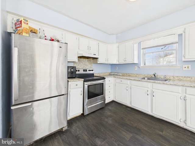 kitchen with dark wood-style flooring, a sink, white cabinets, under cabinet range hood, and appliances with stainless steel finishes