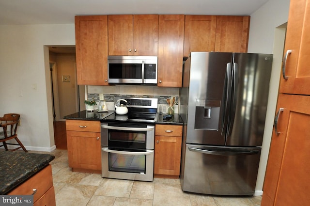 kitchen featuring stainless steel appliances, backsplash, and brown cabinetry