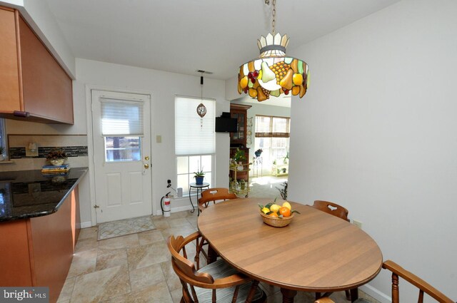 dining area with a wealth of natural light and baseboards