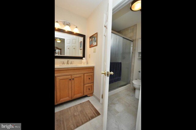 full bathroom with a stall shower, toilet, and vanity