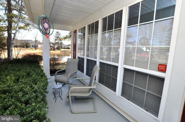 view of patio with a porch and a water view