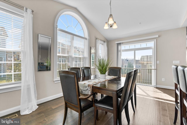 dining room with visible vents, baseboards, dark wood-style flooring, and vaulted ceiling